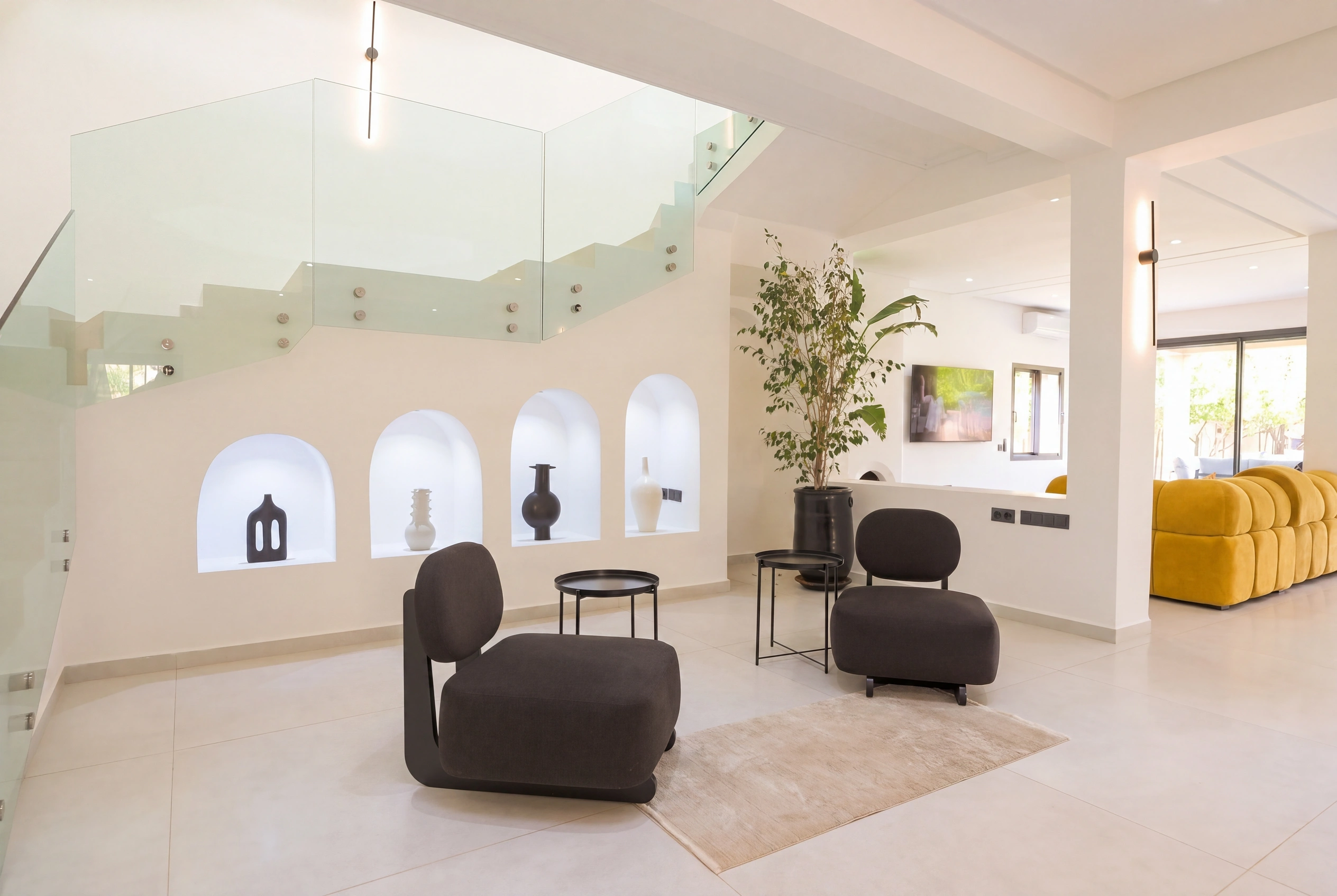 Villa Adam — Interior entrance with illuminated Moroccan arches and glass staircase